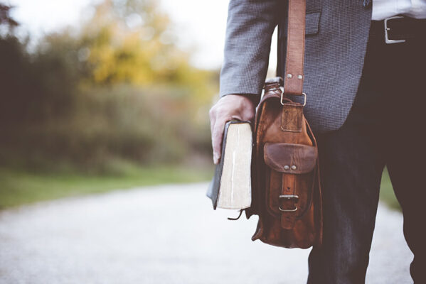 closeup-shot-male-wearing-bag-hilding-bible