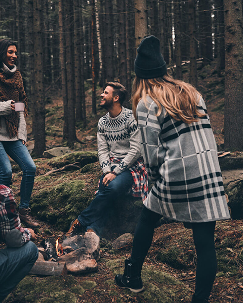 life-filled-with-friendship-group-happy-young-people-standing-around-campfire-while-hiking-woods (1)